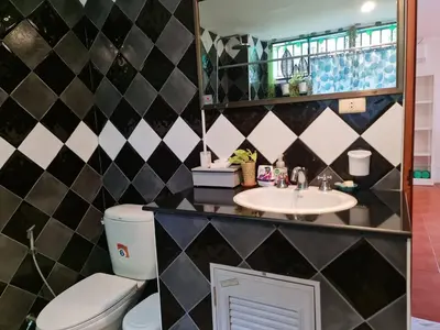 a bathroom with a toilet and a sink at Grand Luxe Kamala in Kamala Beach