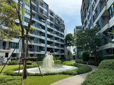 a fountain in a park in front of a building at Centrio Condominiums Top Floor with Pool and Garden view in Ban Na Khua