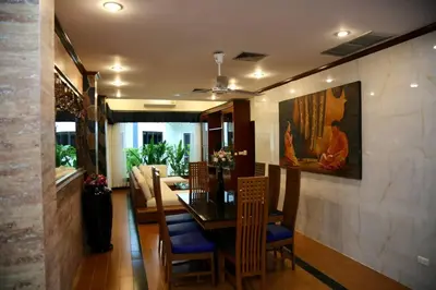 a dining room with a table and chairs and a painting at 4-5 bedroom Villa At Kamala Beach, Pool in Kamala Beach