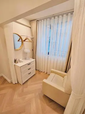 a living room with a white couch and a mirror at Baan 112 Patong in Patong Beach