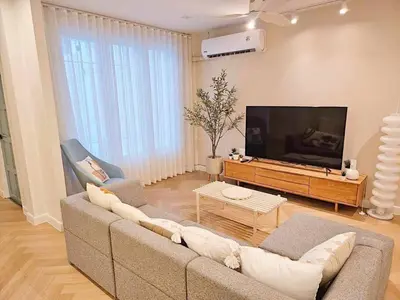 a living room with a couch and a flat screen tv at Baan 112 Patong in Patong Beach