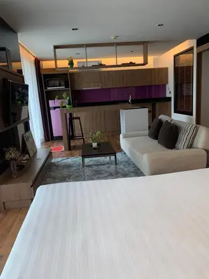 a living room with a white bed and a couch at Luxury Suite Room by Atlas X in Kata Beach