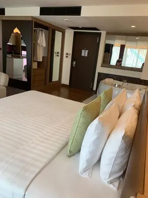 a bedroom with a large bed with pillows at Luxury Suite Room by Atlas X in Kata Beach