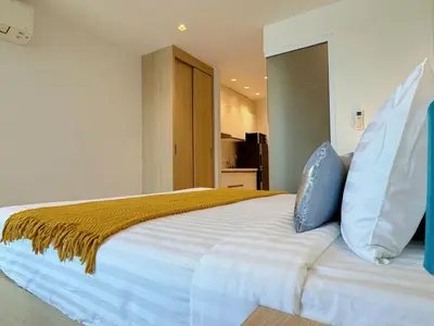 a bedroom with a large white bed with pillows at Cozy Studio Rawai Beach Phuket in Ban Saiyuan (1)