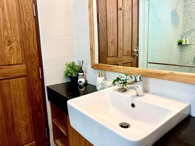 a bathroom with a white sink and a mirror at 208 Ao Nang, Private Sea View Pool Villa in Krabi town