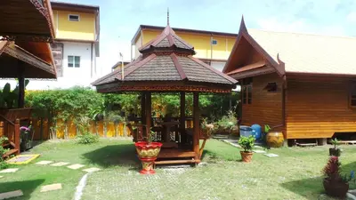 a gazebo in the yard of a house at Golden Teak Resort Baan Sapparot in Kamala Beach