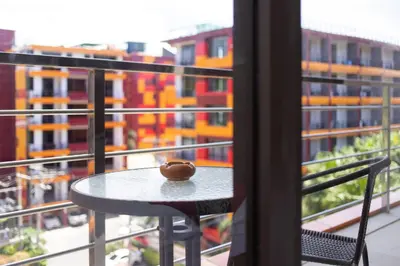 a table with a donut on top of it on a balcony at Nai Harn Beach Condominimum in Phuket Town