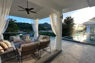 a patio with a table and chairs on a balcony at Luxurious 5 bedroom 5 bathroom Gym Views v138 in Kamala Beach