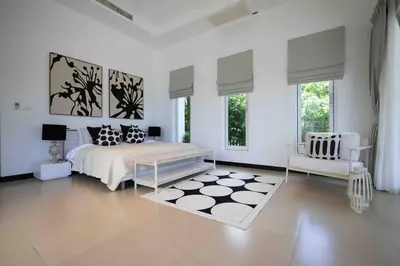 a white bedroom with a bed and a chair at Luxurious 5 bedroom 5 bathroom Gym Views v138 in Kamala Beach