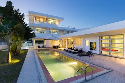 a large house with a swimming pool in front of it at Secluded Paradise Your Exclusive Villa Retreat V82 in Rawai Beach