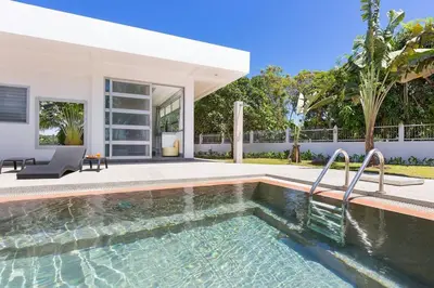 a swimming pool in front of a house at Secluded Paradise Your Exclusive Villa Retreat V82 in Rawai Beach