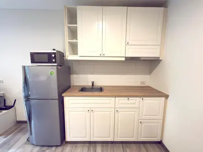 a kitchen with a refrigerator and a sink at The Title Residencies Naiyang by Mill in Nai Yang Beach