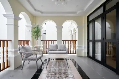 a living room with a couch and chairs and a table at Hawa House Phuket in Phuket Town