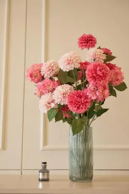 a vase filled with pink flowers sitting on a table at Hawa House Phuket in Phuket Town