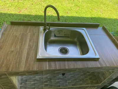 a stainless steel sink in a wooden counter top at Mukda in Ko Yao Noi