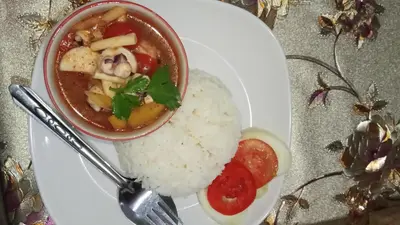 a plate of food with a bowl of soup and rice at Mukda in Ko Yao Noi