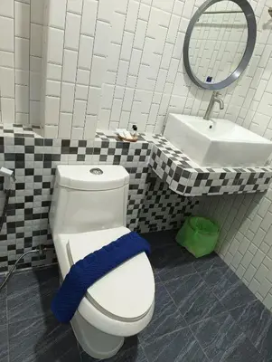 a bathroom with a white toilet and a sink at Hello Montri in Klong Muang Beach