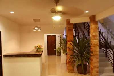 a hallway with a staircase and a stair case at The Seashore Kamala Service Apartment in Kamala Beach