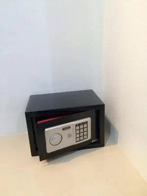 a black microwave oven sitting on a wall at The Seashore Kamala Service Apartment in Kamala Beach