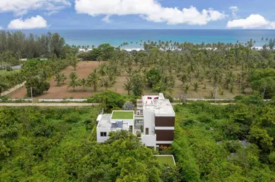 an aerial view of a house with the ocean in the background at Villa White Skies in Khok Kloi