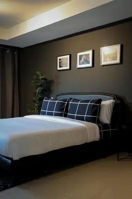 a bedroom with a bed with blue and white pillows at Black Turtle in Koh Lone
