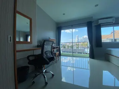 a room with a desk and a chair and a window at ZEN Hotel Patong Beach -ex- miami Production in Patong Beach