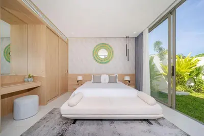 a bedroom with a large white bed and a large window at Luxury villa near Bangtao beach in Phuket Town
