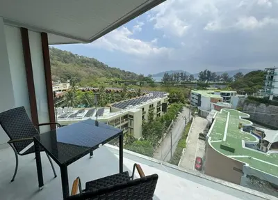 a balcony with a table and chairs and a view at Private sea view studio at Twin Sands in Patong Beach