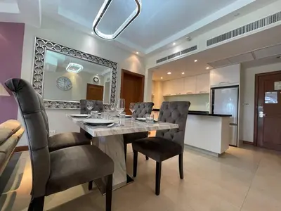 a dining room with a table and some chairs at Allamanda Laguna 2 BR c выходом к бассейну in Phuket Town