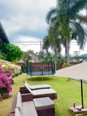 a park with a bench and a playground at The White House Kamala Phuket in Kamala Beach
