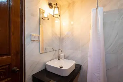 a bathroom with a white sink and a mirror at Cozy Villa 4 Bedrooms Patong,7mins. walk beach/10mns.Bangla Rd in Patong Beach