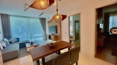 a living room with a table and a couch at Kamala Falls Seaview 2 bedroom in Kamala Beach