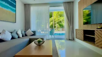 a living room with a couch and a table at Kamala Falls Seaview 2 bedroom in Kamala Beach