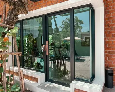 a sliding glass door with a patio in the background at Title V Lemon Fresh Pool View Gym Hammam in Rawai Beach