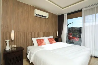 a bedroom with a white bed and a window at 2 bdr Apartment Calypso Garden NaiHarn Beach by Capital Pro CGC-310 in Rawai Beach