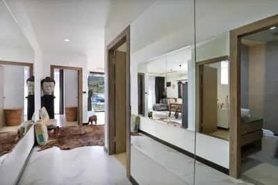 a hallway with glass doors and a living room at 2 bdr Apartment Calypso Garden NaiHarn Beach by Capital Pro CGC-310 in Rawai Beach