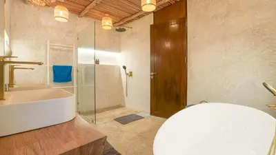 a bathroom with a tub and a sink and a shower at Recently renovated 3BR apartment near Layan Beach in Phuket Town