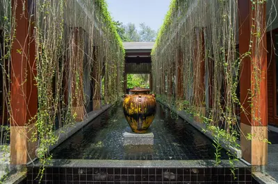 a large vase sitting in the middle of a hallway at Modern Beachfront Apartment Naithon Beach in Nai Thon Beach
