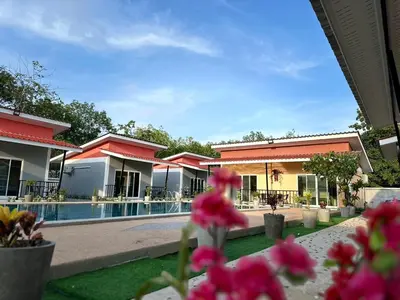 a resort with a swimming pool and pink flowers at พัชรี รีสอร์ท ภูเก็ต Patcharee Resort Phuket in Phuket Town