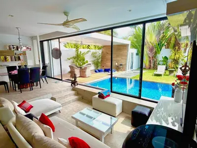 a living room with a pool and a large window at VILLA Pak Dang in Phuket Town