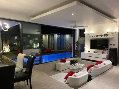 a living room with a large aquarium in the wall at VILLA Pak Dang in Phuket Town