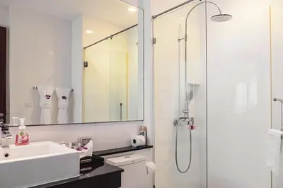 a white bathroom with a sink and a shower at Krabi One Bedroom Seaview in Klong Muang Beach