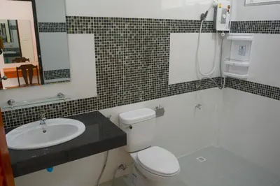 a bathroom with a toilet and a sink and a shower at VK House Rawai, Phuket in Rawai Beach