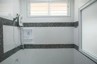 a bathroom with a shower and a window at VK House Rawai, Phuket in Rawai Beach