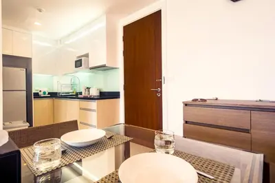 a kitchen with a table with two bowls on it at Krabi Luxury Penthouse in Klong Muang Beach