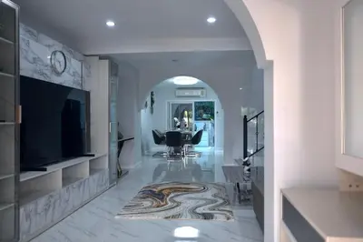 a hallway with a living room with a table and a television at GORGEOUS NEW DESIGNED 4br KataBeach sweetHome in Kata Beach