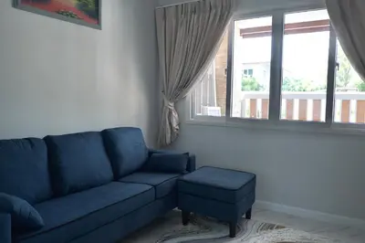 a blue couch and a stool in a living room at GORGEOUS NEW DESIGNED 4br KataBeach sweetHome in Kata Beach