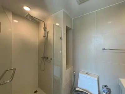 a bathroom with a shower and a toilet at Top floor apartment at Aristo by Lofty in Surin Beach