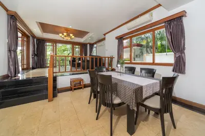 a dining room with a table and chairs at Villa Aurora 4-bedroom Pool Villa in Kamala, Phuket in Kamala Beach