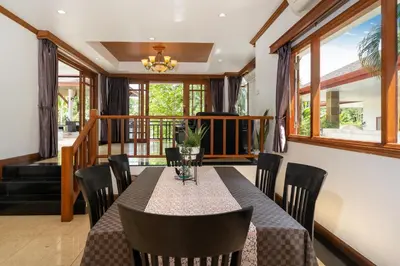 a dining room with a table and chairs at Villa Aurora 4-bedroom Pool Villa in Kamala, Phuket in Kamala Beach